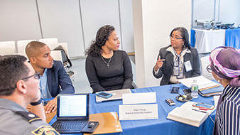 group of people talking around a table